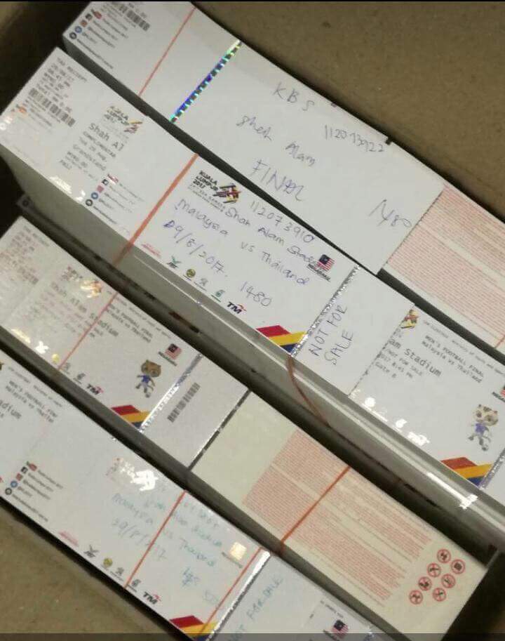 A picture widely circulated via Facebook purportedly showing a large stack of tickets placed in a box, and wrapped around markers captioned ‘for KBS officials’.