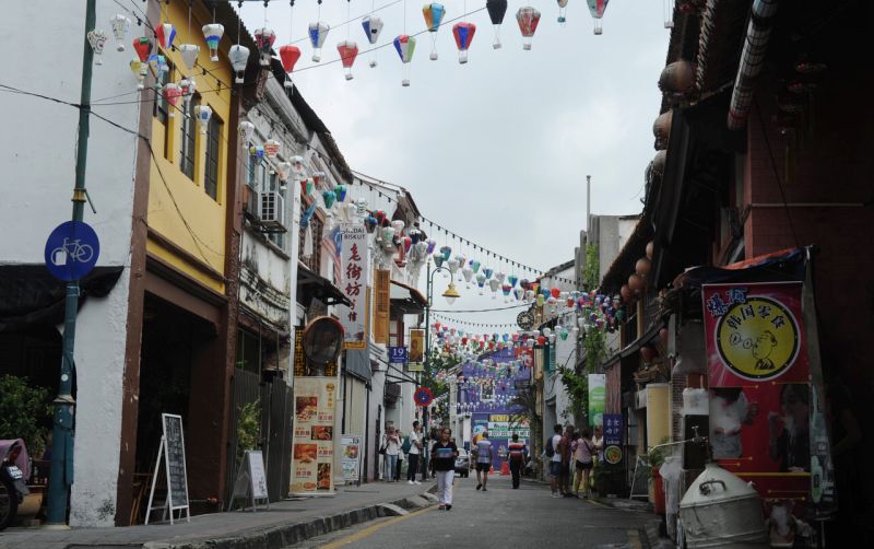 People walk past pre-war shophouses in George Townu00e2u20acu2122s heritage area on August 16, 2017. u00e2u20acu2022 Bernama pic