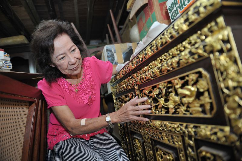 It took Yuen many hours of painstaking labour layering the gold leaf onto the motifs on this Peranakan furniture.