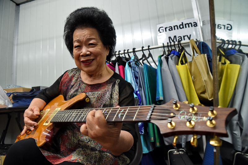 This picture taken on August 5, 2017 shows Mary Ho, also known as Grandma Mary, posing with her electric guitar during a rehearsal in Singapore. u00e2u20acu201d AFP pic