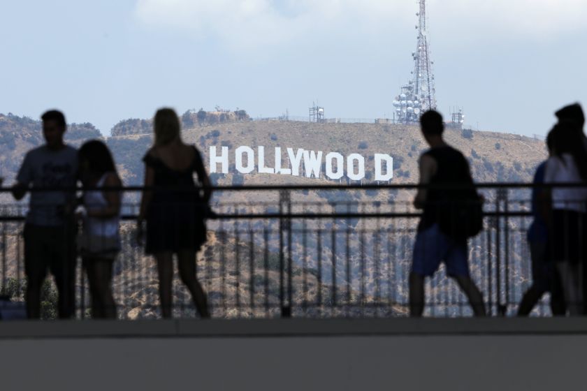 Tourists walk past the Hollywood sign as they visit a shopping complex along Hollywood Boulevard, California August 4, 2017. u00e2u20acu201d Reuters pic