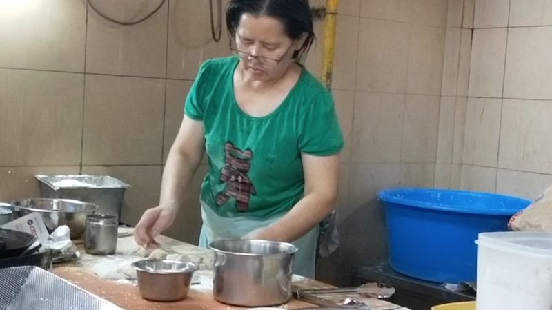 Second-generation hawker Li Shu Hui took over the hum chim peng business from her father seven years ago, and has continued the incidental tradition of letting customers fry their own hum chim pengs. — TODAY pic 
