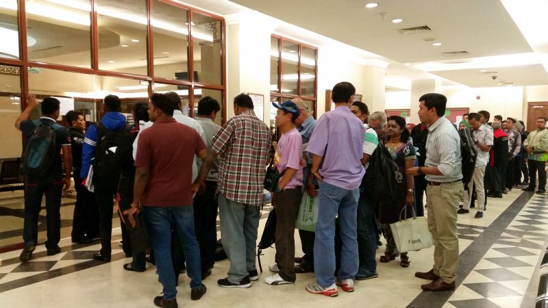 By 8am, everyone — runners, despatch workers, lawyers — takes up their spot in the queue as they wait to take their queue numbers from a machine at the e-filing service bureau. July 27, 2017. — Picture by Ida Lim