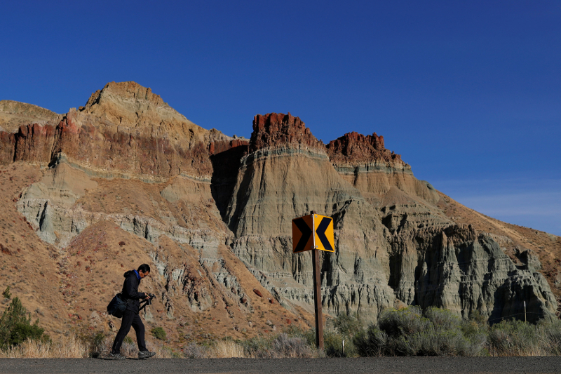 Michael Lee of Seattle, with camera in hand, walks past Cathedral Rock formation in preparation for the total lunar eclipse near John Day Fossil Beds National Monument in Kimberly, Oregon August 20, 2017. u00e2u20acu201d Reuters pic