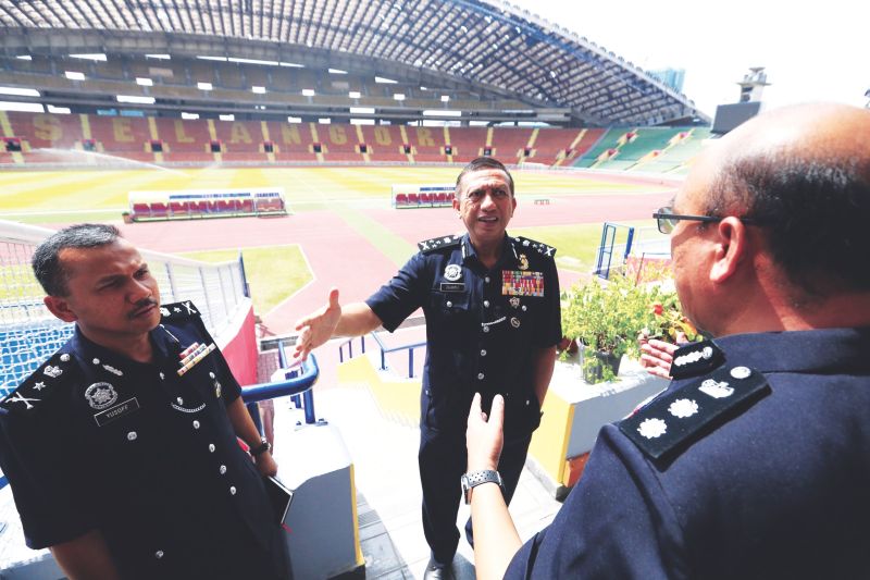 (From left) Mohd Yusoff, Zulkifli and Shafien discuss security measures to be put in place at Shah Alam Stadium. u00e2u20acu201d Picture by Zuraneeza Zulkifli