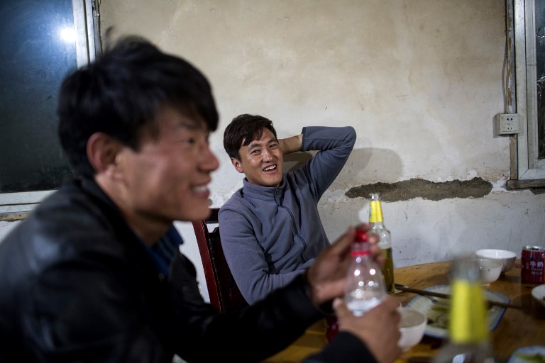 This picture taken on May 27, 2017 shows Trinley Norbu (R) and Tsultrim Paldzone sitting in a restaurant in Zhaba in the valley of the Yalong River in Daofu County of the Garze Tibetan Autonomous Prefecture. u00e2u20acu201d AFP pic