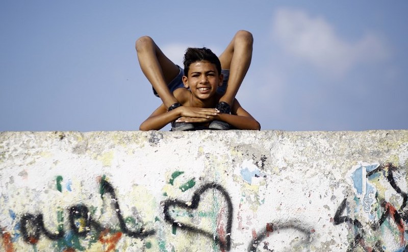 Yousef Al-Bahtini, a 12-year-old Palestinian boy invited to attempt the record attempt for u00e2u20acu02dcfastest time to travel 20 metres in a contortion rollu00e2u20acu2122 by Guinness World Records, shows off his acrobatic skills in Gaza City September 20, 2017. u00e2u20acu201d AFP pic