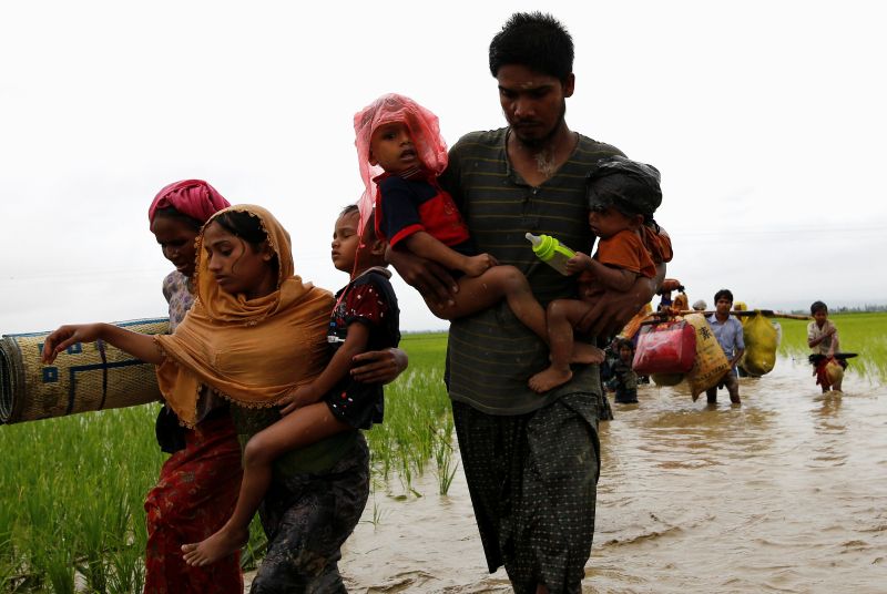 A group of Rohingya refugees carry their children as the wade across water after travelling over the Bangladesh-Myanmar border in Teknaf, Bangladesh, September 1, 2017. u00e2u20acu201d Reuters pic