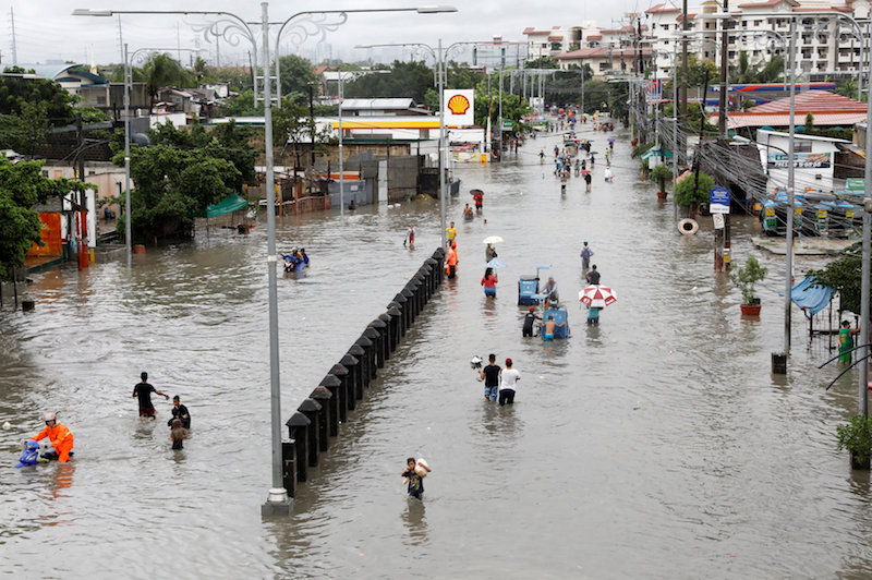 Residents wade and ride on pedicabs along a partially flooded road, in Las Pinas Metro Manila as a storm sweeps across the main Luzon island, Philippines, September 12, 2017.u00c2u00a0u00e2u20acu201d Reuters pic