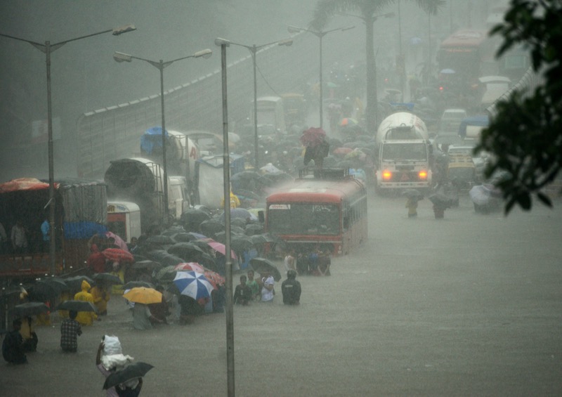 People wade along a flooded street during heavy rain showers in Mumbai on August 29, 2017. u00e2u20acu201d AFP pic