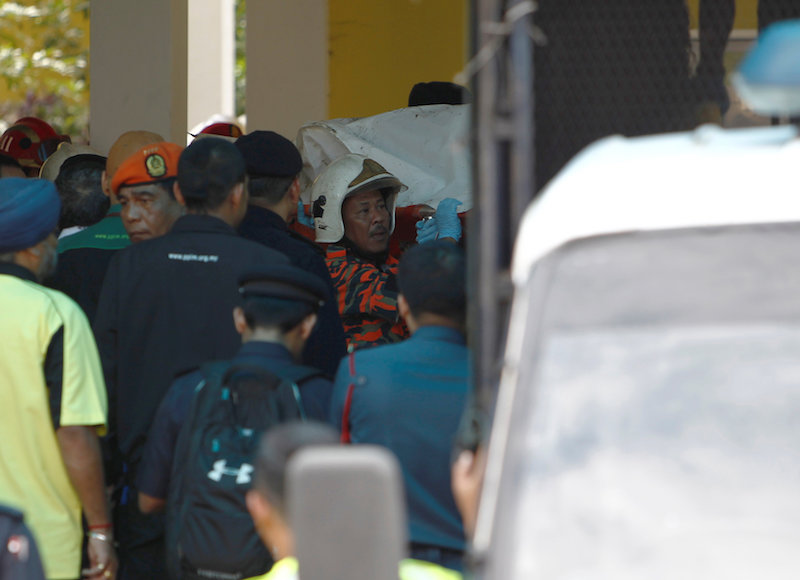 Firefighters carry a body out of the Darul Quran Ittifaqiyah religious school in Kuala Lumpur after a fire broke out, September 14, 2017. u00e2u20acu201d Reuters pic