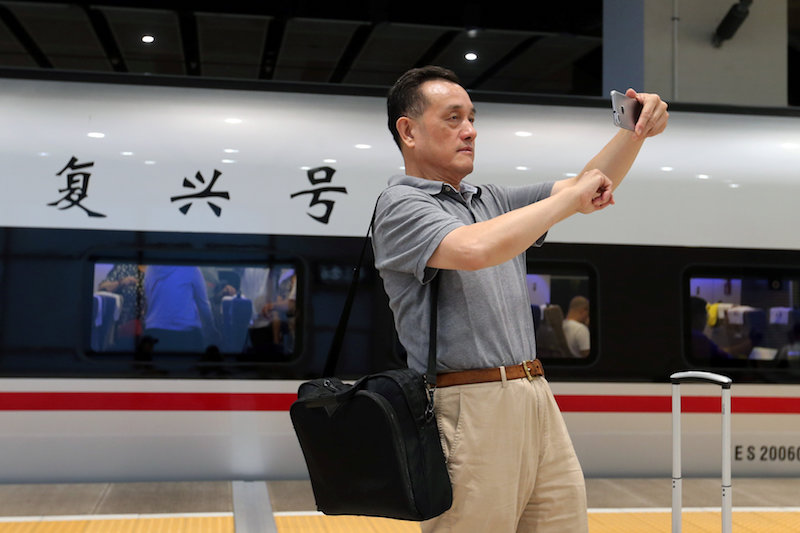A passenger takes a selfie with a Fuxing bullet train before it departs from Beijing South Railway Station to Shanghai, in Beijing September 21, 2017. u00e2u20acu201d Reuters pic