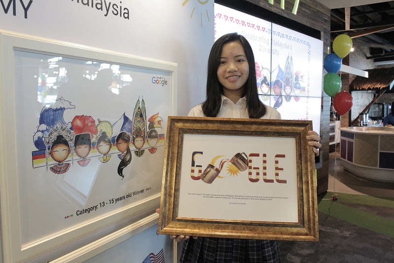 Grand winner Chu00e2u20acu2122ng Kai Wei holding the official 2015 Merdeka doodle while proudly posing with her winning doodle (left). u00e2u20acu201d Picture courtesy of Google