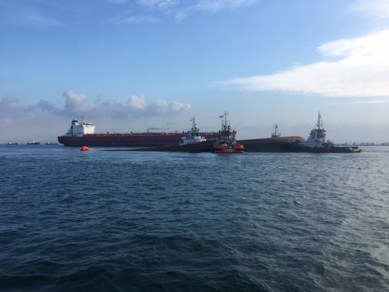Four tug boats moving the partially submerged dredger safely to an area near Pulau Senang for follow up underwater search operation. u00e2u20acu201d Picture courtesy of Maritime and Port Authority of Singapore via TODAY
