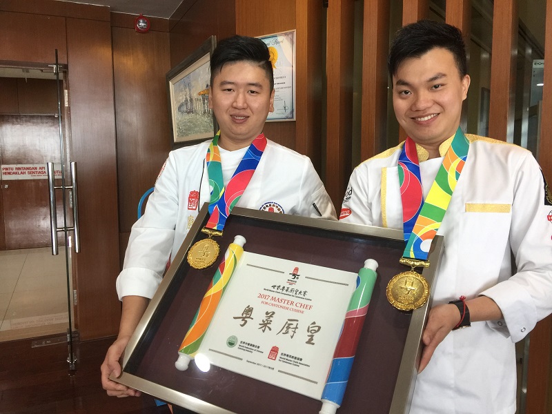 Gary Lim and Jason Lim (right) showing their medals and World Master Chef Competition Gold Medal winner certificate. u00e2u20acu201d Picture by Opalyn Mok