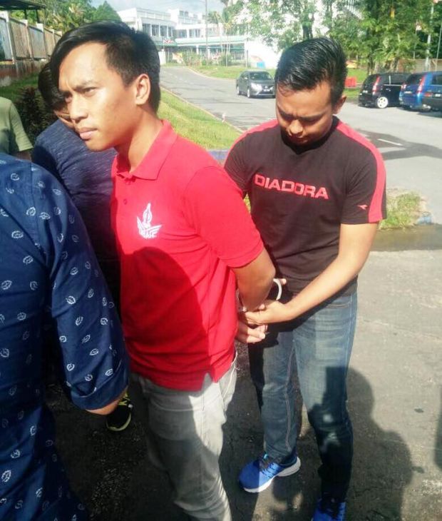 Abdul Aziz Isa is being handcuffed after he was arrested by the police for posting remarks against Prime Minister Datuk Seri Najib Razak, September 16, 2017. u00e2u20acu2022 Picture courtesy of Chong Chieng Jenu00e2u20acu2122s Facebook page.