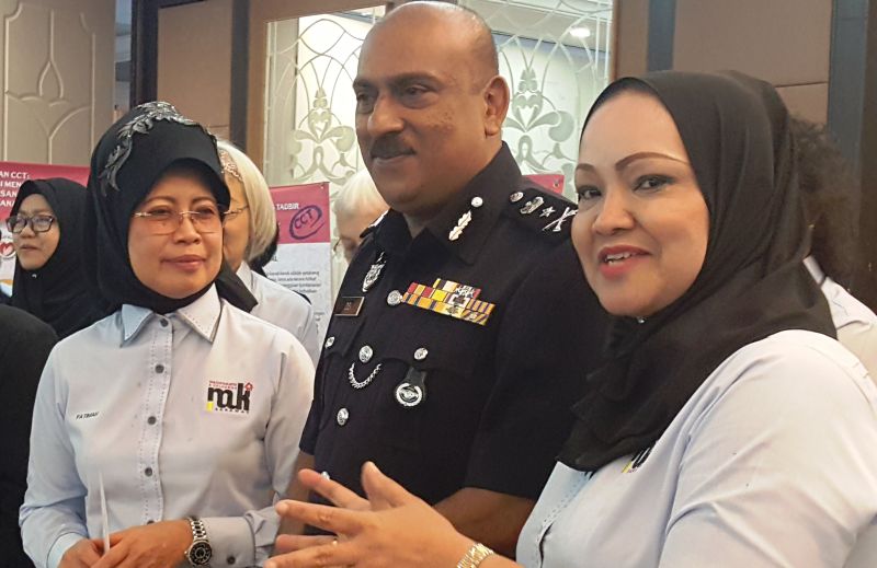 Fatimah Abdullah (left) is pictured with Sarawak Criminal Investigation Department (CID) head Datuk Dev Kumar, after the women and family council meeting on September 11, 2017. u00e2u20acu201d Picture by Sulok Tawie