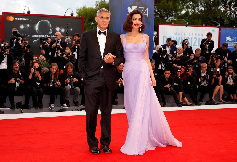 Actor and director George Clooney and his wife Amal pose during a red carpet event for the movie u00e2u20acu02dcSuburbiconu00e2u20acu2122 at the 74th Venice Film Festival in Venice, Italy September 2, 2017. u00e2u20acu201d Reuters pic
