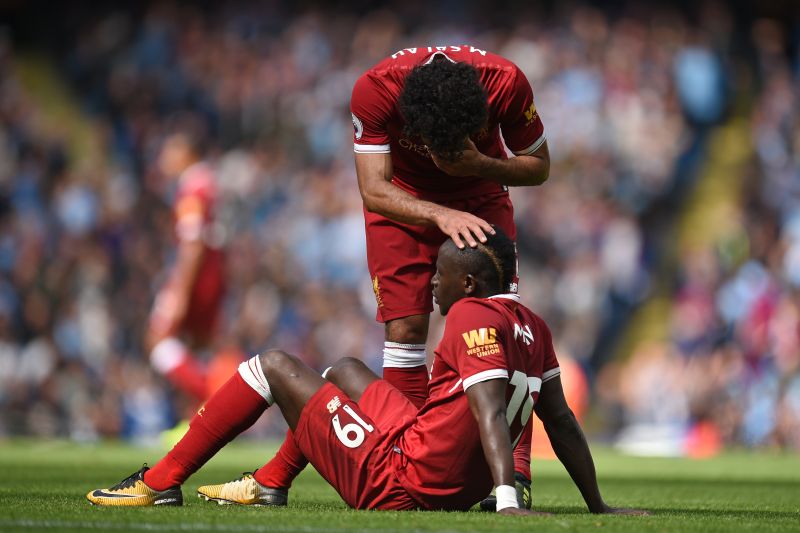 Liverpoolu00e2u20acu2122s Egyptian midfielder Mohamed Salah (up) consoles Liverpoolu00e2u20acu2122s Senegalese midfielder Sadio Mane after he makes a dangerous challenge on Manchester Cityu00e2u20acu2122s Brazilian goalkeeper Ederson during the English Premier League football match between 