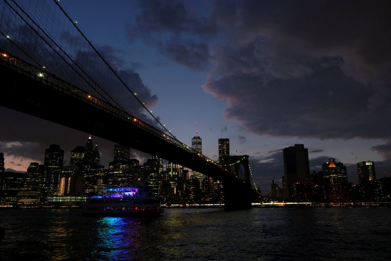A ferry boat passes under Brooklyn Bridge in front of the night skyline of Lower Manhattan in New York City, US, at dusk, September 16, 2017. u00e2u20acu2022 Reuters pic