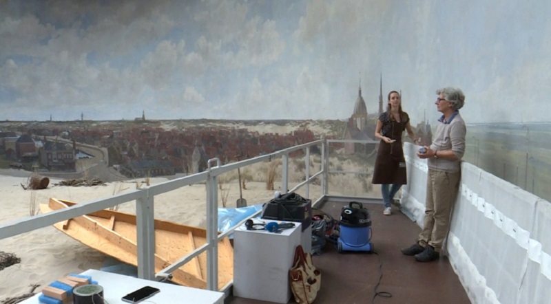 Art restorers Leonoor Speldekamp (right) and Jorinde Koenen work on a raised platform during restoration work on the u00e2u20acu02dcPanorama Mesdagu00e2u20acu2122 by Dutch painter Hendrik Willem Mesdag in The Hague. u00e2u20acu201d AFP pic
