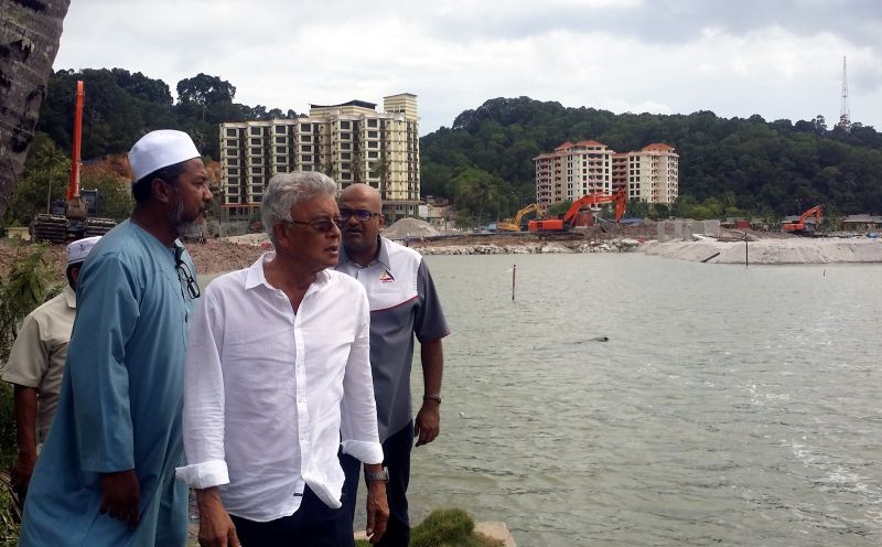 (From left) Zulkifli, Razali and Joseph at the site where construction of apartments are under way on reclaimed land. u00e2u20acu201d Picture by Loghun Kumaran 