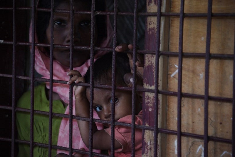 A Rohingya Muslim refugee and child look on as they sit in a school housing new refugees from Myanmar in Kutupalong refugee camp in the Bangaldeshi district of Ukhia on September 23, 2017. u00e2u20acu201d AFP pic