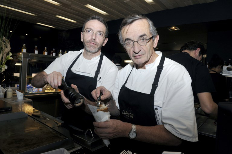 This file photo taken on January 24, 2014 shows French chefs Michel Bras (right) and his son Sebastien Bras posing as they prepare a buckwheat flour wrap called u00e2u20acu02dcLe Capucinu00e2u20acu2122 at their restaurant u00e2u20acu02dcCapucinu00e2u20acu2122 in Toulouse. u00e2u20acu201d AFP