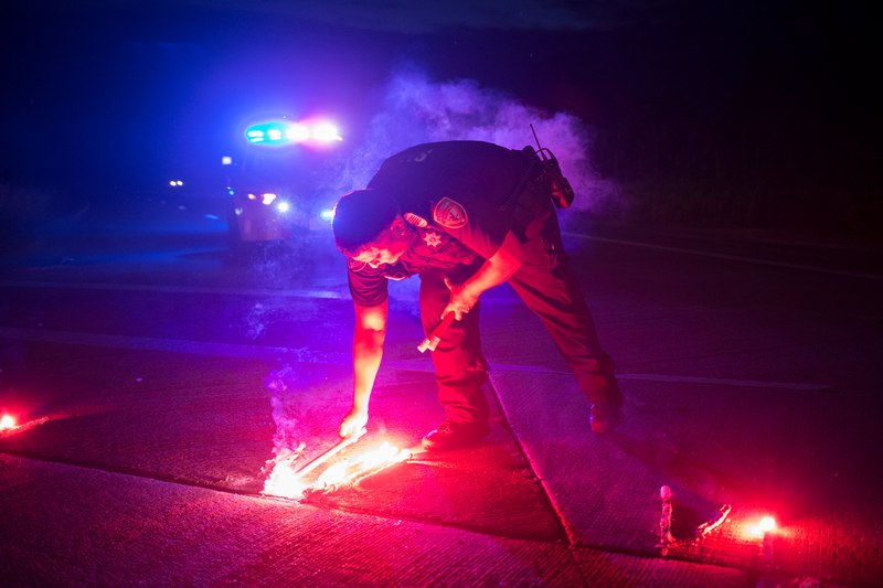 A police officer lays down a safety flare while blocking the road leading to the Arkema SA plant which was hit by floods caused by tropical storm Harvey near Crosby, Texas August 31, 2017. u00e2u20acu201d Reuters pic