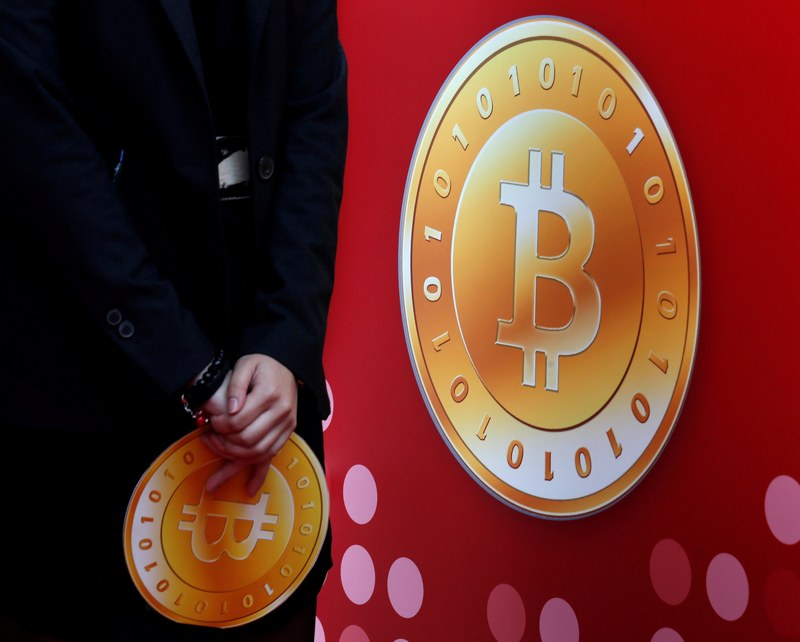 An attendant holds a bitcoin sign during the opening of Hong Kong's first bitcoin retail store February 28, 2014. u00e2u20acu201d Reuters pic