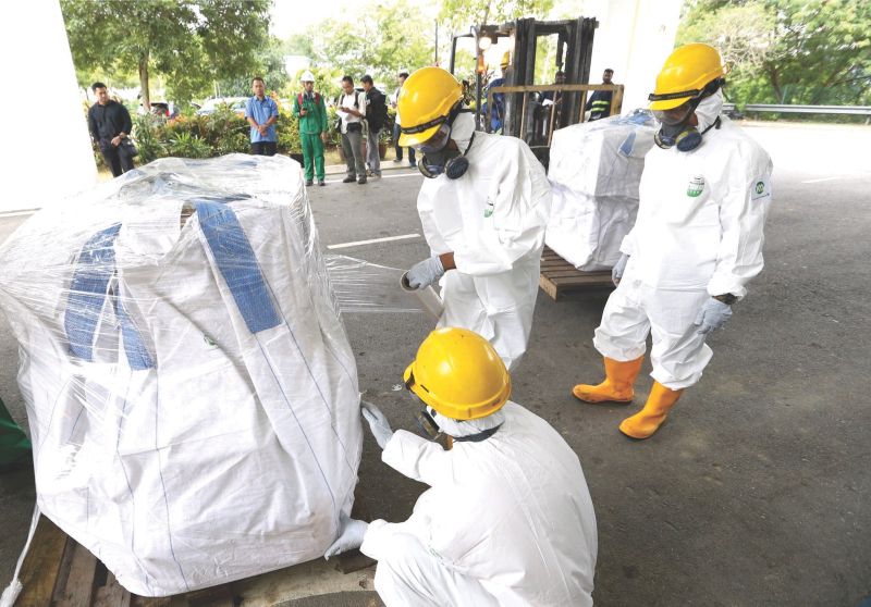 Narcotics officers package the drugs to be transported for incineration at Port Dickson, Negri Sembilan. 