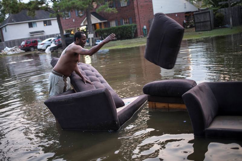 Vince Ware moves his sofas onto the sidewalk from his house which was left flooded from Tropical Storm Harvey in Houston September 3, 2017. u00e2u20acu201d Reuters pic 
