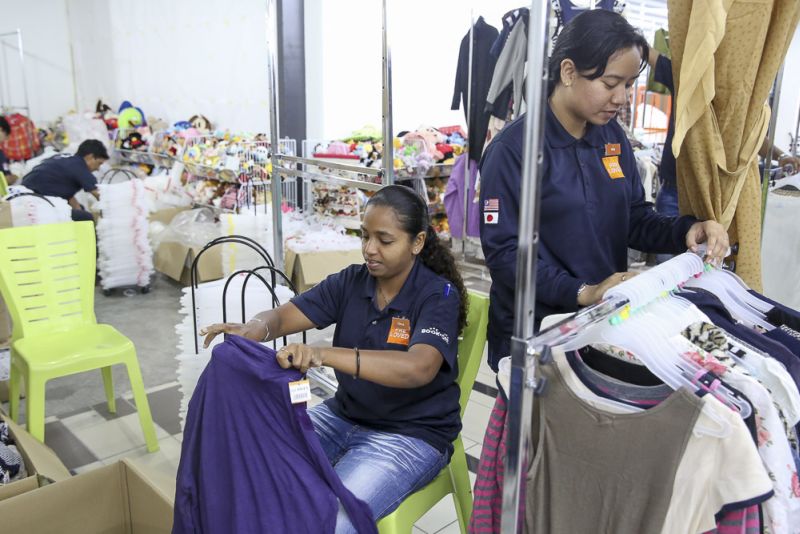 Jalan Jalan Japan staff sorts out the preloved and new items at the new store. 