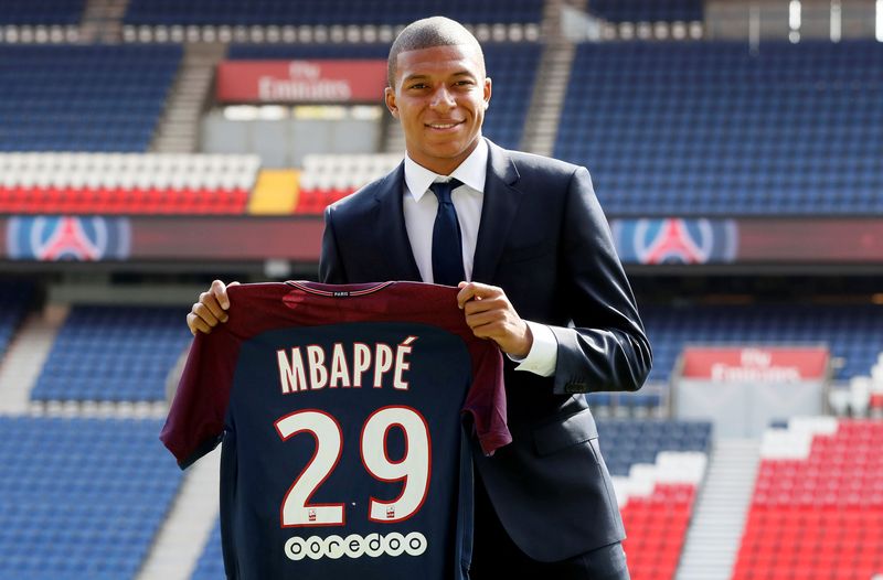 New Paris St Germain signing Kylian Mbappe poses with the club shirt after a press conference in Paris, September 6, 2017. u00e2u20acu201d Reuters pic