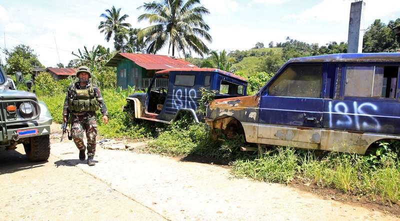A soldier patrols a deserted mountain village after pro-Islamic State militants had left on the outskirts of Marawi city, southern Philippines September 5, 2017. A Singapore suspect has been arrested of planning to join IS-linked fighters in the Philippin
