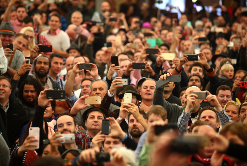 Visitors take pictures with their phones during the opening day of the 184th Oktoberfest in Munich September 17, 2017. u00e2u20acu201d Reuters pic