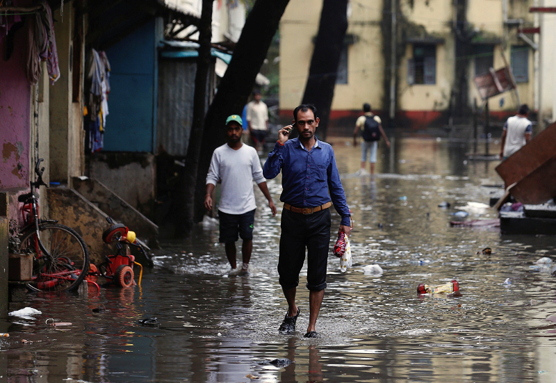 People walk through a partially flooded street at a residential area in Mumbai August 30, 2017. u00e2u20acu201d Reuters pic