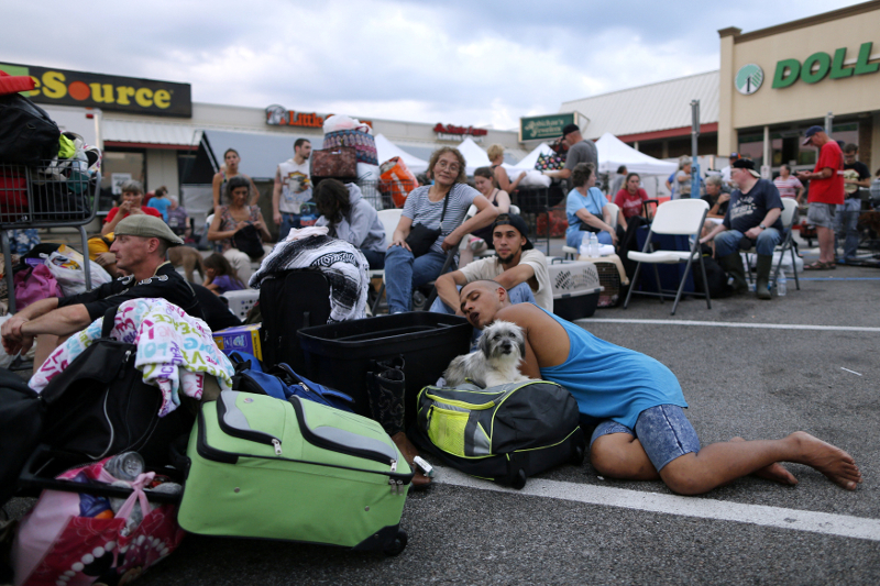 Evacuees who were rescued from the flood waters of Tropical Storm Harvey wait to board school buses bound for Louisiana in Vidor, Texas on August 31, 2017. u00e2u20acu201d Reuters pic