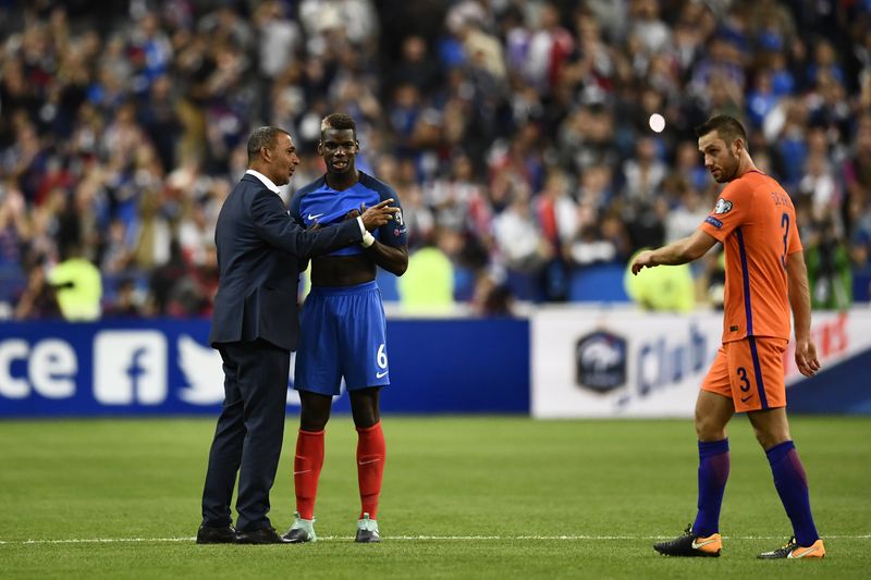 Dutch assistant coach Ruud Gullit (left) talks to Franceu00e2u20acu2122s midfielder Paul Pogba (centre) after the 2018 Fifa World Cup qualifying football match France vs Netherlands at the Stade de France in Saint-Denis, August 31, 2017. u00e2u20acu201d AFP pic