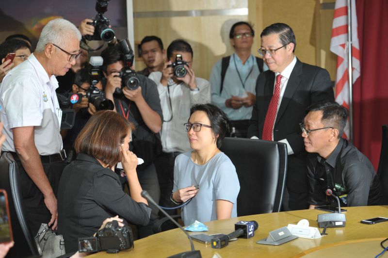 Ariess Tan (left) listening to her late daughter's heart beating in Serene Lee's chest while Mark Kok Wah (right) looks on in an emotional meeting. u00e2u20acu2022 Picture by KE Ooi