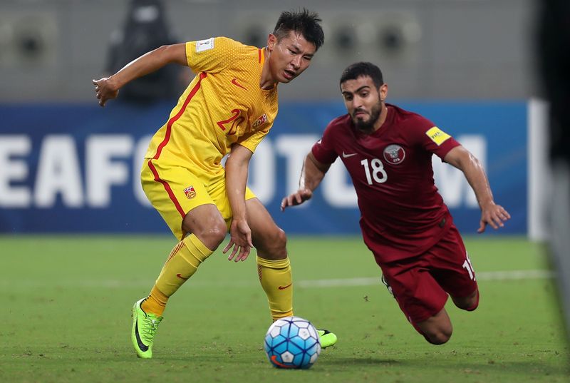 Chinau00e2u20acu2122s Yu Hanchao (left) and Qataru00e2u20acu2122s Abdulkareem Salem fight for the ball during the Fifa World Cup 2018 qualification football match between Qatar and China at the Jassim Bin Hamed Stadium in Doha on September 5, 2017. u00e2u20acu201d AFP pic