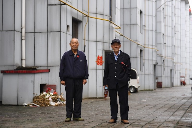 Two men stand outside an apartment building in Nanjie village, in China’s central Henan province, September 27, 2017. — AFP pic