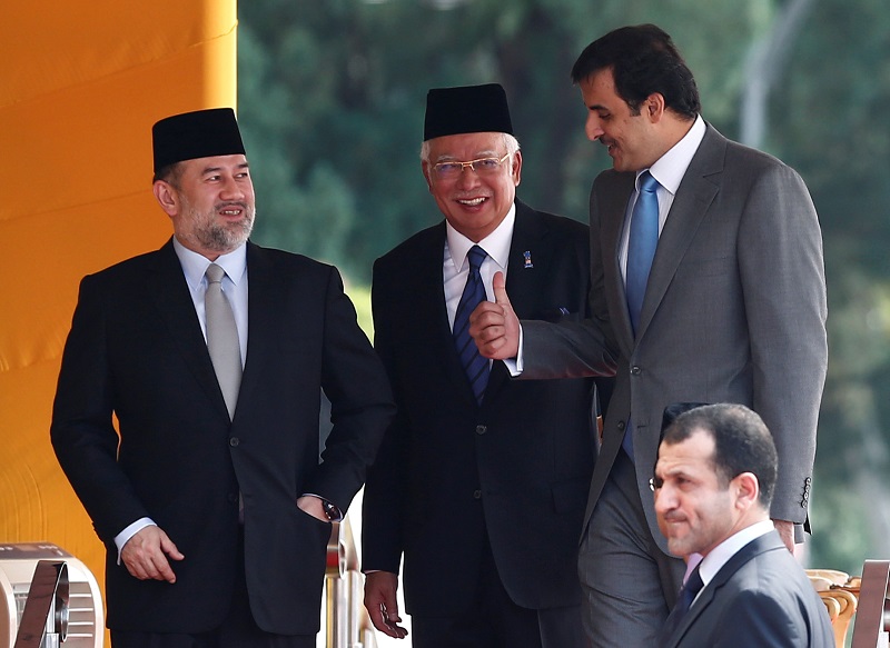 Qataru00e2u20acu2122s Emir Sheikh Tamim bin Hamad al-Thani (right) speaks with prime minister Datuk Seri Najib Razak and Yang di-Pertuan Agong Sultan Muhammad V after a state welcome ceremony at the Parliament House in Kuala Lumpur October 16, 2017. u00e2u20acu201d Reuters pic