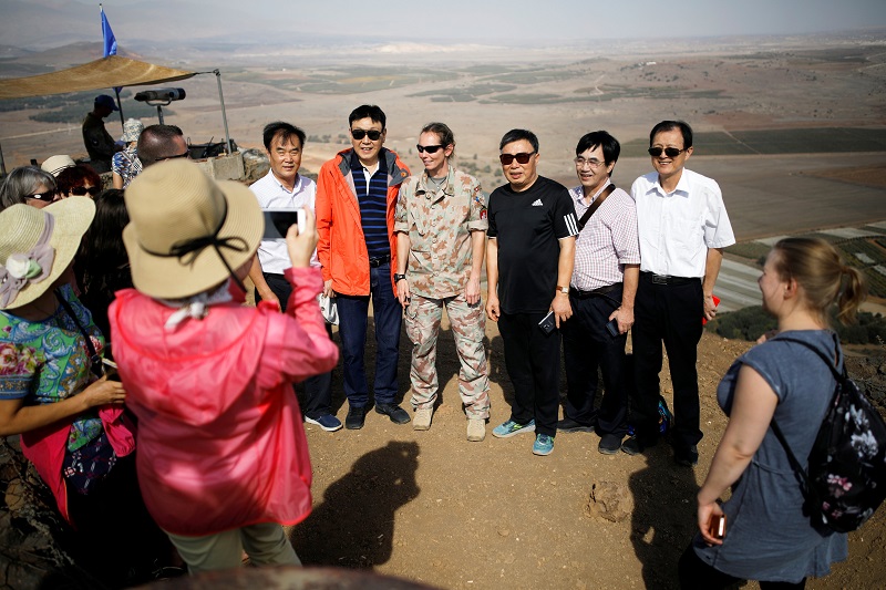 Tourists pose for a photo with a UN peacekeeper at Mount Bental, an observation post in the Israeli occupied Golan Heights near the ceasefire line between Israel and Syria October 24, 2017. u00e2u20acu201d Reuters pic 