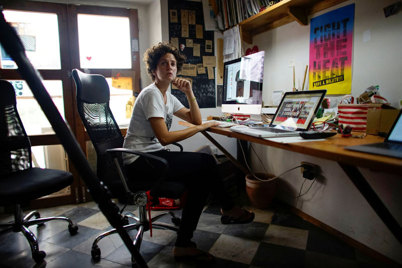 Cuban private design store Clandestina co-founder and creative director Idania del Rio talks to an employee (not pictured) at her office in Havana October 23, 2017. — Reuters pic