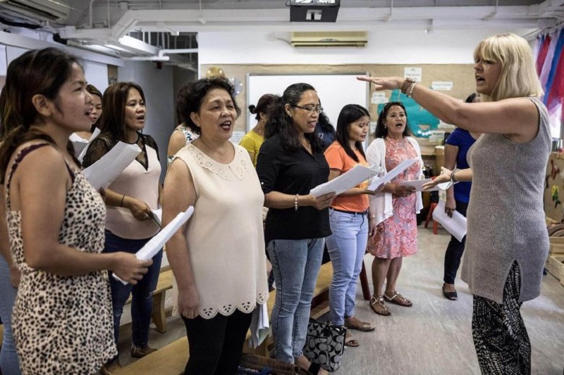 Unsung Heroes choir founder Jane Englemann leads her group of Filipina domestic workers during a practice session inside a kindergarten schoolu00e2u20acu2122s classroom in Hong Kong September 3, 2017. u00e2u20acu201d AFP pic