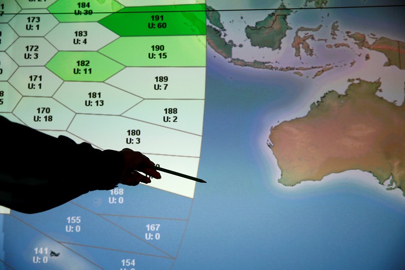A member of staff at satellite communications company Inmarsat poses in front of a section of the screen showing the southern Indian Ocean to the west of Australia, at their headquarters in London March 25, 2014.  u00e2u20acu201d Reuters pic