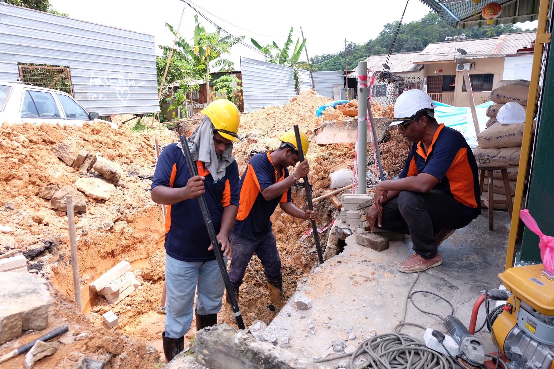 Contractors working on the new drainage system to divert the river water away from the critical area in Penang October 5, 2017. Picture by KE Ooi