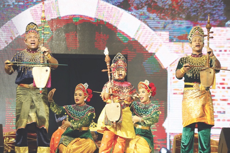 Kamarul Baihaqui (centre) awes the crowd with his rebab skills during his groupu00e2u20acu2122s Mak Yong performance at Dataran Merdeka yesterday. u00e2u20acu201d Picture by Azinuddin Ghazali