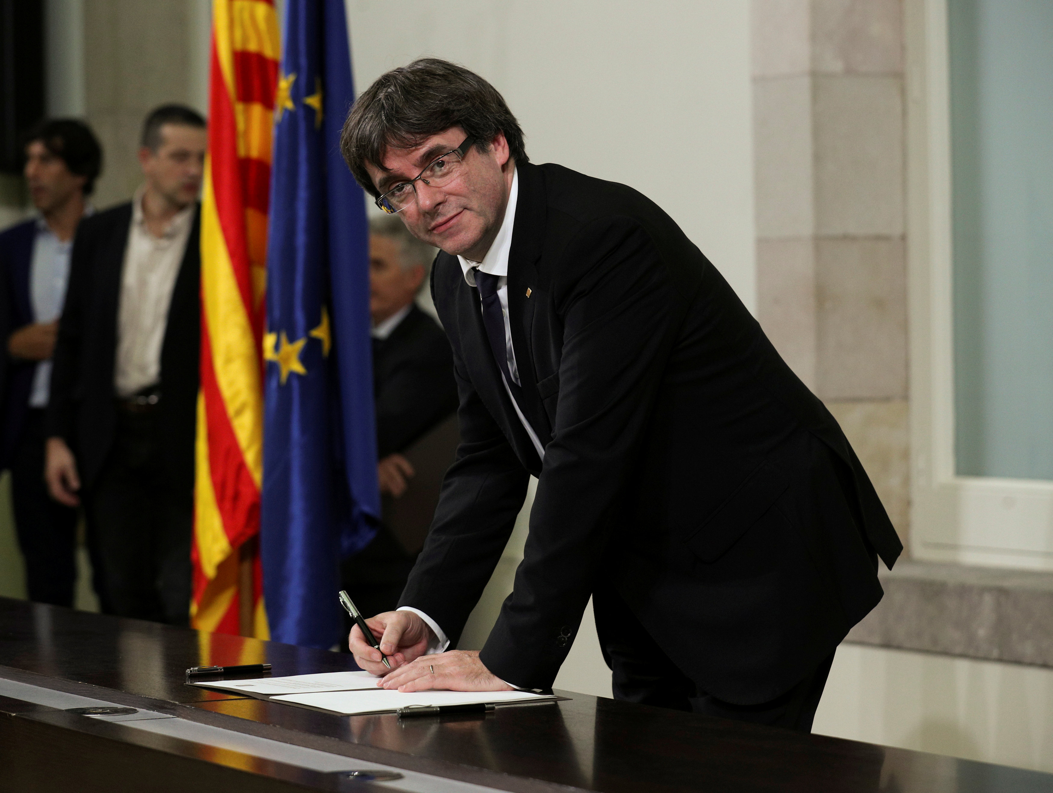 Catalan President Carles Puigdemont signs a declaration of independence at the Catalan regional parliament in Barcelona, Spain, October 10, 2017. u00e2u20acu201d Reuters pic 